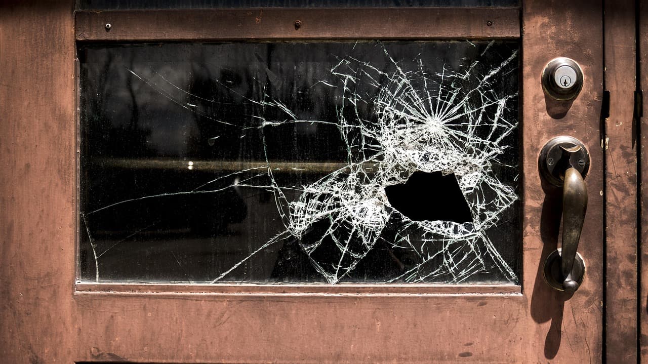 A door with a smashed glass panel after a break-in