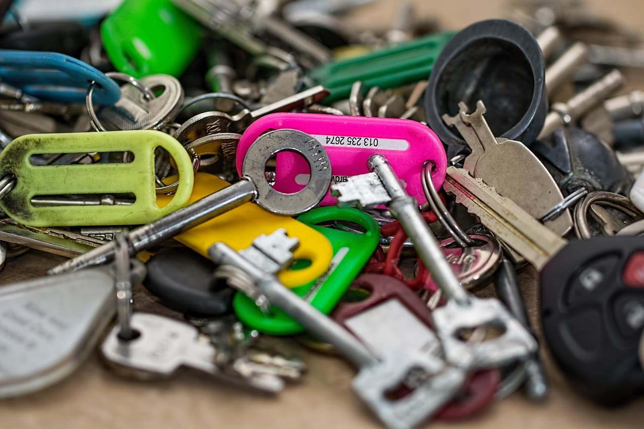 A pile of house keys and coloured key tags